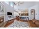Open-concept living area with high ceilings, a fireplace, a modern kitchen, and lots of natural light at 5403 Avenal Dr, Lutz, FL 33558