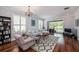 Cozy living room featuring hardwood floors, plantation shutters, and a sliding glass door at 5403 Avenal Dr, Lutz, FL 33558