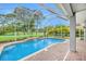 Screened-in pool area with waterfall feature, perfect for relaxation and entertainment at 5403 Avenal Dr, Lutz, FL 33558