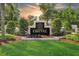 Beautifully landscaped Cheval community sign with manicured lawn, flowers, and hedges at 5403 Avenal Dr, Lutz, FL 33558