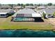 Home featuring a screened-in pool area with scenic lake views, perfect for relaxation and entertainment at 613 Fort Duquesna Dr, Sun City Center, FL 33573