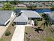 Beautiful waterfront home featuring solar panels, a two-car garage, and well-maintained landscaping at 613 Fort Duquesna Dr, Sun City Center, FL 33573