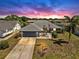Charming single-story home with a well-manicured lawn, an American flag, and a spacious two-car garage at 613 Fort Duquesna Dr, Sun City Center, FL 33573