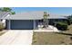 Inviting single-story home with a well-kept lawn and a spacious two-car garage at 613 Fort Duquesna Dr, Sun City Center, FL 33573