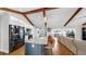 Spacious kitchen featuring a large island, breakfast bar, and stainless steel appliances, open to living area at 613 Fort Duquesna Dr, Sun City Center, FL 33573