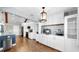 Modern kitchen featuring white cabinetry, stainless steel appliances, and a stylish pendant light fixture at 613 Fort Duquesna Dr, Sun City Center, FL 33573
