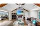 Cozy living room with a fireplace, TV, vaulted ceilings and comfortable seating at 613 Fort Duquesna Dr, Sun City Center, FL 33573