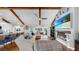 Spacious living room with vaulted ceilings, exposed beams, a fireplace, and comfortable seating at 613 Fort Duquesna Dr, Sun City Center, FL 33573