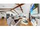 Stunning living room features vaulted ceilings with wood beams and a cozy fireplace at 613 Fort Duquesna Dr, Sun City Center, FL 33573