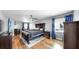 Bright main bedroom featuring a sitting area, fan, and hardwood floors at 613 Fort Duquesna Dr, Sun City Center, FL 33573
