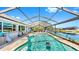 A stunning view of the screened-in pool, with access to the lake at 613 Fort Duquesna Dr, Sun City Center, FL 33573