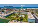 Aerial view of condo complex with a pool, lush landscaping, close proximity to the beach, and Gulf of Mexico access at 6161 Gulf Winds Dr # 338, St Pete Beach, FL 33706