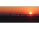 Beach sunset with people in silhouette looking out towards the ocean at 6161 Gulf Winds Dr # 338, St Pete Beach, FL 33706