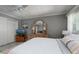 Bedroom with a bed, a dresser with a large mirror, and a TV, offering a relaxing and inviting space at 6161 Gulf Winds Dr # 338, St Pete Beach, FL 33706