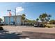 Charming exterior showcasing guest parking, building signage, and mature palm trees at 6161 Gulf Winds Dr # 338, St Pete Beach, FL 33706