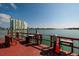 Waterfront condo complex with a private dock that includes seating, tables, and grilling stations at 6161 Gulf Winds Dr # 338, St Pete Beach, FL 33706