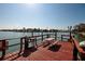 Waterfront dock featuring a picnic table and a grilling area with views of the surrounding neighborhood at 6161 Gulf Winds Dr # 338, St Pete Beach, FL 33706