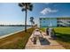 Waterfront common area includes barbecue grilling stations, picnic tables, and green space with mature trees at 6161 Gulf Winds Dr # 338, St Pete Beach, FL 33706