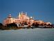 Beautiful beachfront hotel with unique architecture, lush greenery, and a serene beach at dusk at 6161 Gulf Winds Dr # 338, St Pete Beach, FL 33706