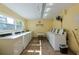 Well-lit laundry room with multiple washing machines, a folding table, and a clean, functional space at 6161 Gulf Winds Dr # 338, St Pete Beach, FL 33706