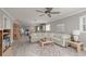 Comfortable living area featuring a sectional sofa, wood-look floors, and a view into the dining area at 6161 Gulf Winds Dr # 338, St Pete Beach, FL 33706
