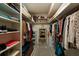 Organized walk-in closet with shelves, hanging rods, a small vanity, and ample storage for clothes and accessories at 6161 Gulf Winds Dr # 338, St Pete Beach, FL 33706