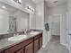 Modern bathroom features dual sinks, granite countertop, and a walk-in shower at 6325 Shore Vista Pl, Apollo Beach, FL 33572