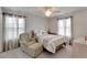 Comfortable bedroom with a cozy chair, a bed with decorative pillows, and bright natural light at 6325 Shore Vista Pl, Apollo Beach, FL 33572