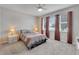Sunlit bedroom with soft carpet, a ceiling fan, and large windows for natural light at 6325 Shore Vista Pl, Apollo Beach, FL 33572