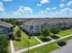 Inviting two-story home featuring a manicured lawn, lush landscaping, and a welcoming facade at 6325 Shore Vista Pl, Apollo Beach, FL 33572