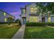 Inviting townhome featuring tidy landscaping, stone accents, and a charming blue front door at 6325 Shore Vista Pl, Apollo Beach, FL 33572
