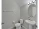 Neutral half-bathroom with pedestal sink, toilet, mirror and tiled floors at 6325 Shore Vista Pl, Apollo Beach, FL 33572