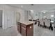 Spacious kitchen with granite island that overlooks the dining area and stairs at 6325 Shore Vista Pl, Apollo Beach, FL 33572