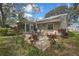 Large backyard with a patio, landscaping, and mature trees, offering plenty of space for outdoor activities at 6375 Ocean Pines Ln, Spring Hill, FL 34606