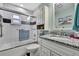 Bathroom featuring granite countertops, tub/shower combo, and vanity with storage at 6375 Ocean Pines Ln, Spring Hill, FL 34606