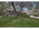 Well-kept exterior, features mature trees, vibrant plants, well-manicured lawn, and inviting curb appeal at 6375 Ocean Pines Ln, Spring Hill, FL 34606