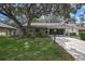 Charming single-story home with mature tree providing shade in the front yard and two-car garage at 6375 Ocean Pines Ln, Spring Hill, FL 34606