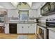 Kitchen features stainless steel appliances, updated countertops, and white cabinetry at 6375 Ocean Pines Ln, Spring Hill, FL 34606
