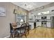 Cozy dining area adjacent to bright kitchen with white cabinets and stainless appliances at 6375 Ocean Pines Ln, Spring Hill, FL 34606