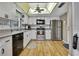 Well-lit kitchen features stainless steel appliances, light wooden flooring, and white cabinetry at 6375 Ocean Pines Ln, Spring Hill, FL 34606