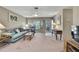 Living room showcases a bay window, neutral carpet, a ceiling fan, and access to the front porch at 6375 Ocean Pines Ln, Spring Hill, FL 34606