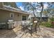 Outdoor patio with a table, chairs, and grill, perfect for entertaining and enjoying the backyard at 6375 Ocean Pines Ln, Spring Hill, FL 34606