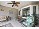 Relaxing covered patio with ceiling fan, neutral tones, and comfortable seating near bright window at 6375 Ocean Pines Ln, Spring Hill, FL 34606