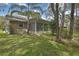 Beautiful yard with mature trees, landscaping, and a screened porch, perfect for relaxation and outdoor enjoyment at 6375 Ocean Pines Ln, Spring Hill, FL 34606