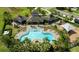 Overhead shot of a community pool, clubhouse, lounge chairs, and playground at 6416 Cobble Bliss St, Zephyrhills, FL 33541