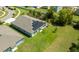 Aerial view of a home with solar panels, a well-maintained lawn, and situated in a quiet neighborhood at 6416 Cobble Bliss St, Zephyrhills, FL 33541