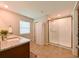 Bright bathroom features granite countertops, large shower, storage closet, and tiled flooring at 6416 Cobble Bliss St, Zephyrhills, FL 33541