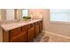 Bathroom vanity with granite countertops, double sinks, storage cabinets and a large mirror at 6416 Cobble Bliss St, Zephyrhills, FL 33541
