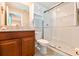 Nicely decorated bathroom featuring granite counters, wood cabinets, and a glass shower enclosure at 6416 Cobble Bliss St, Zephyrhills, FL 33541