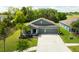 Beautiful single-story home with a well-manicured lawn and a two-car garage at 6416 Cobble Bliss St, Zephyrhills, FL 33541